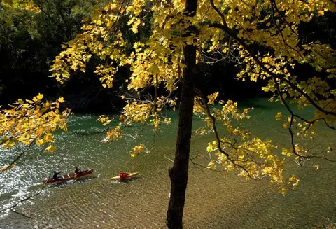 Paddlers on the Buffalo River among fall colors